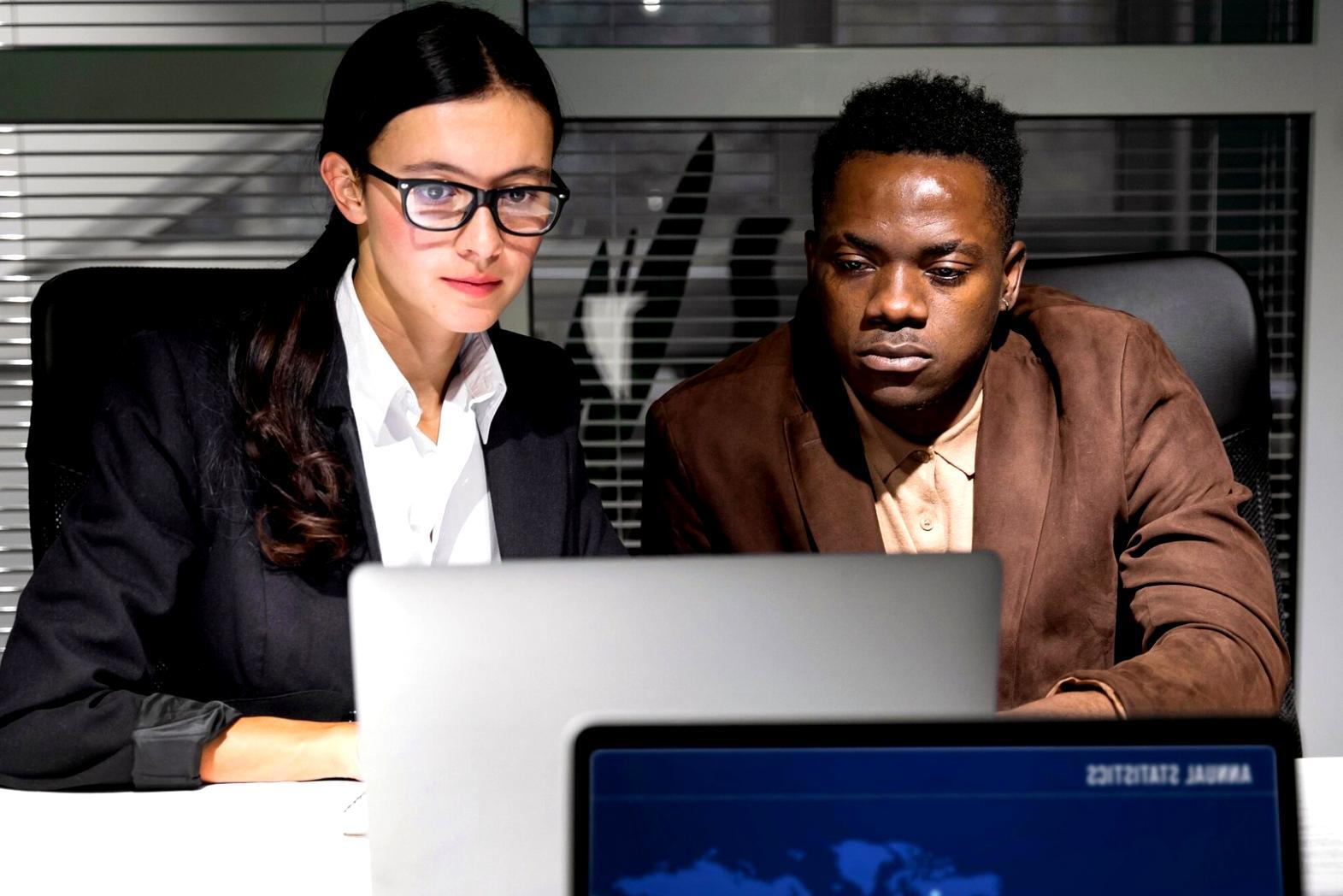 Business professionals analyzing financial data and profitability metrics in collaborative workspace