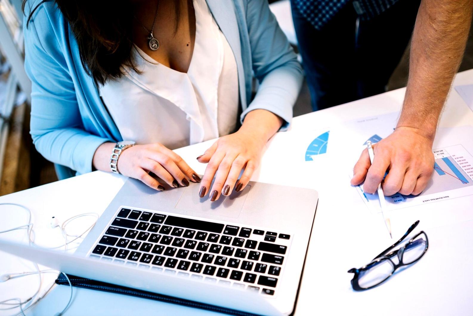 Business owner reviewing quarterly financial reports with highlighted profit margins